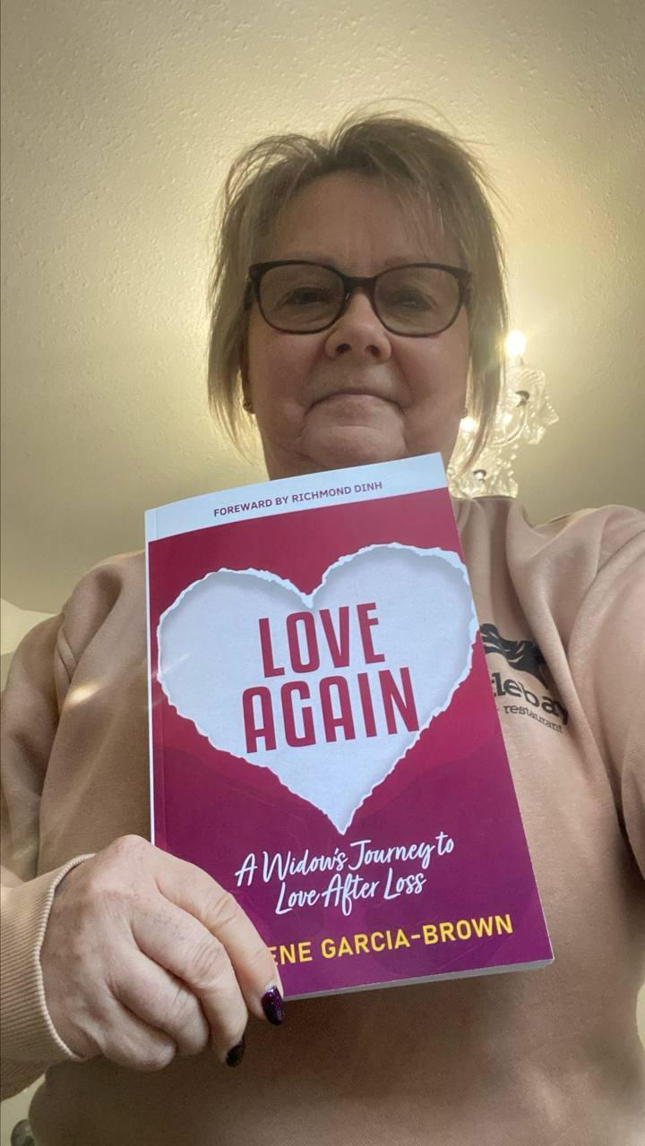 Widow holding Love Again book